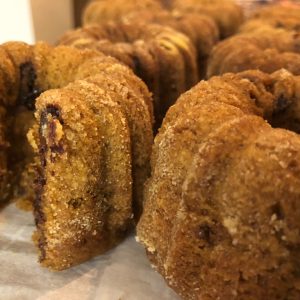 Several banana mini bundt cakes on a wooden board.