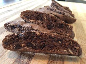 Image of several double chocolate biscotti on a woodent board.