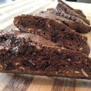 Image of several double chocolate biscotti on a woodent board.