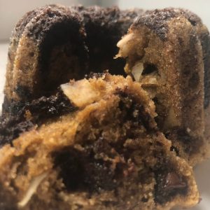 Image of a double coconut double chocolate mini breakfast breads broken in half to show the inside.